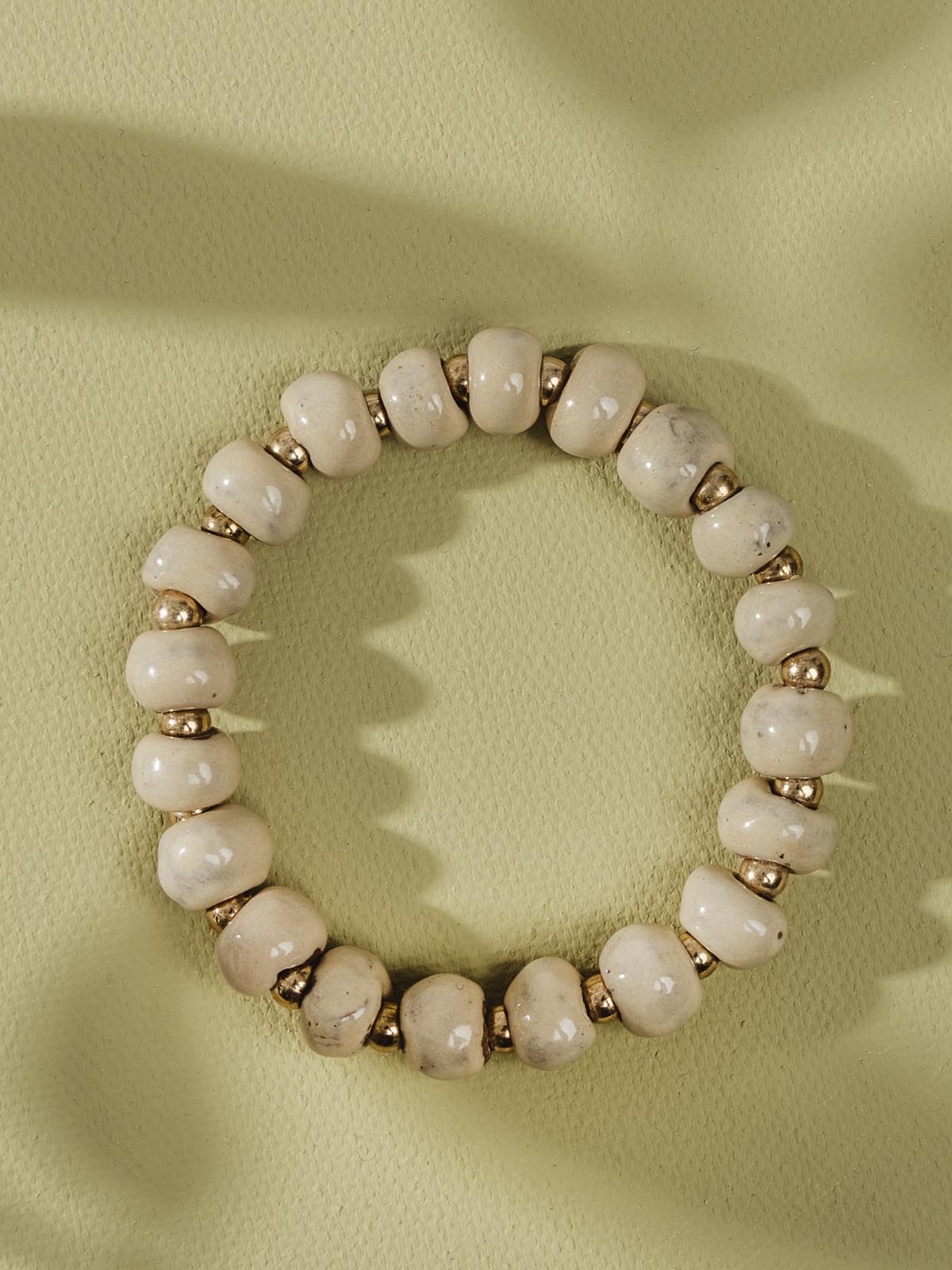 Pink and gold ceramic bead bracelet.