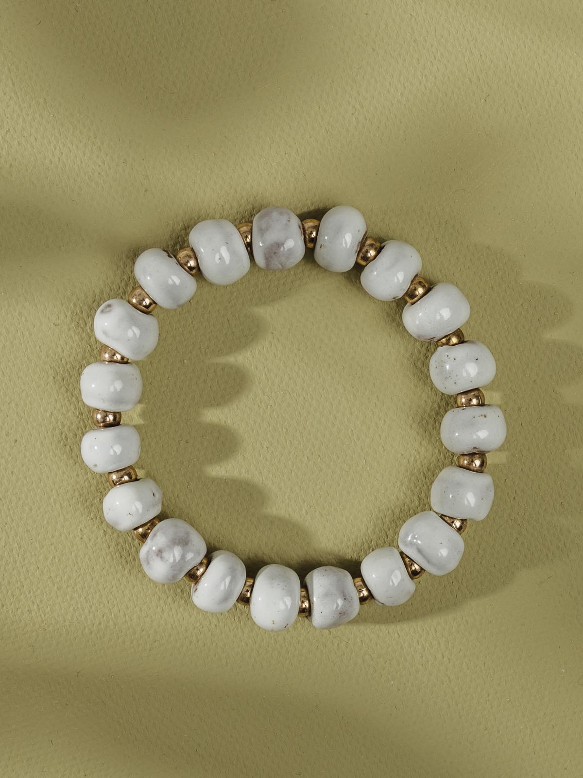 White and gold ceramic bead bracelet.